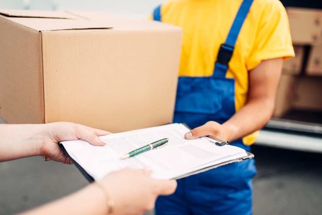 male worker in uniform gives parcel to the client pjr9dy5.jpg